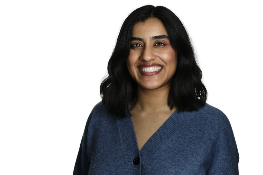 Waterloo therapist headshot: smiling woman in a blue cardigan against a white background.